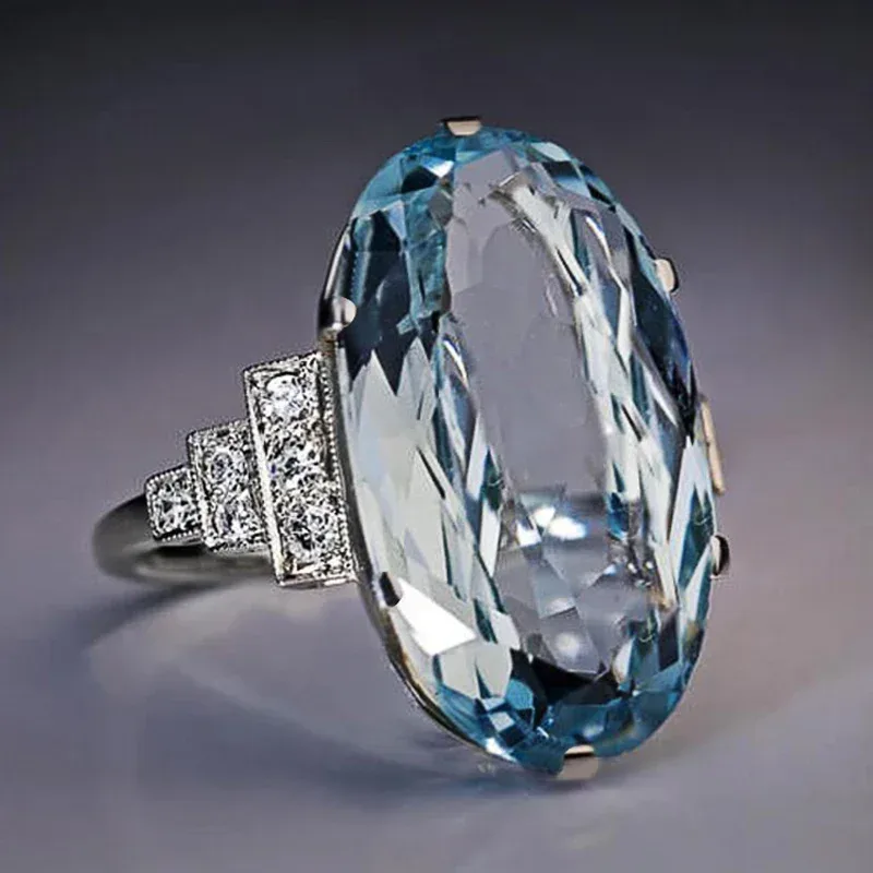 Huitan Weibliche Licht Himmel Blau Ehering Solitaire Band Oval Stein Engage Party Frauen Luxus Schmuck Glanz CZ Stein Beste Geschenk